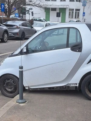 FOTO | Parcare iscusită pe un trotuar din București. Un șofer a lăsat mașina chiar între stâlpișorii care au rolul de a-l opri